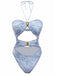 A light blue denim-print one-piece swimsuit featuring a halter neckline, multiple front cut-outs, and decorative gold-tone hardware accents.