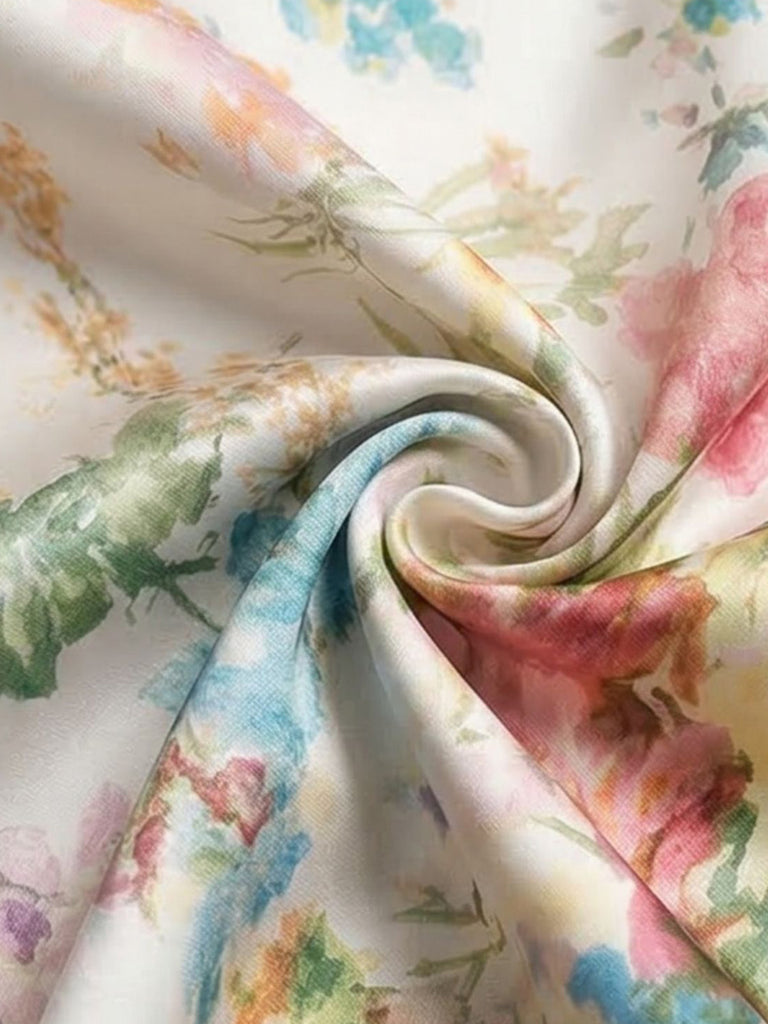 Detailed view of the pink, orange, and blue floral pattern on the dress material.