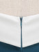 Close-up of a white and blue fabric edge with a beige background