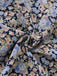 Macro view of the fabric texture and the intricate vintage-style floral pattern on a navy blue background.