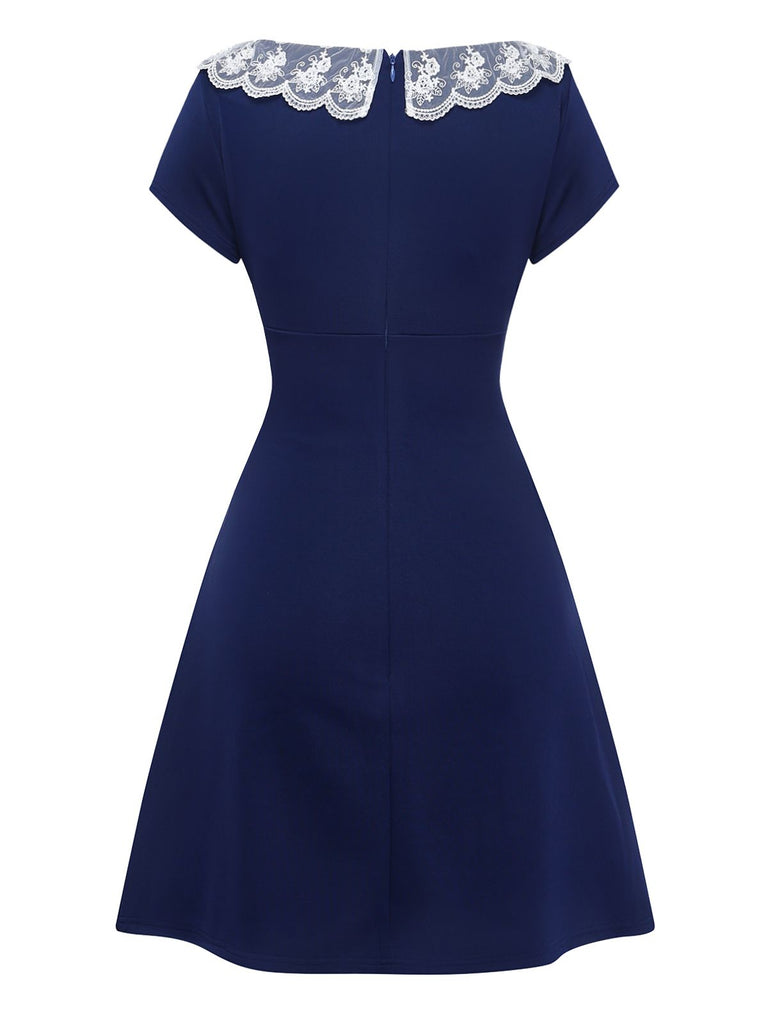 Rear view of the navy blue A-line vintage dress on a white background, showcasing the clean and simple back design.