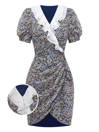 A navy blue mini dress featuring an all-over pink and blue floral print, short puff sleeves, and a prominent white ruffled V-neck collar.