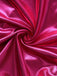 Close-up of pink satin fabric with folds