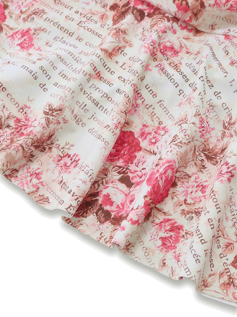 Macro view of the fabric showcasing the romantic rose illustrations and vintage script lettering.