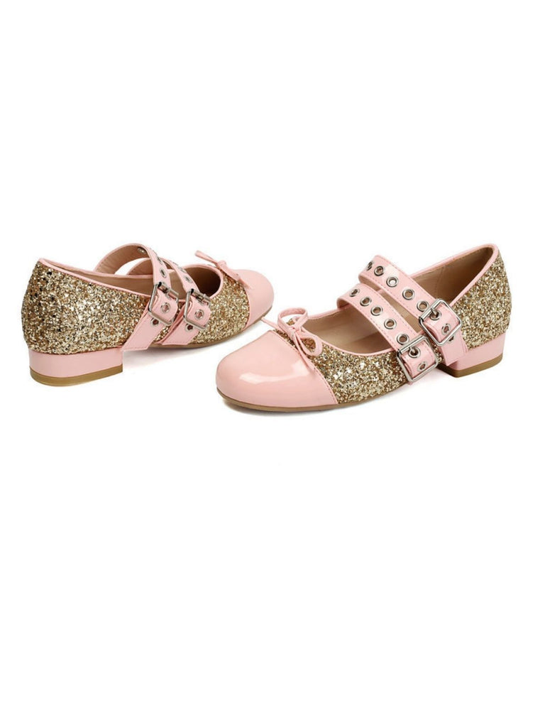 Pair of pink and gold glitter shoes on a white background