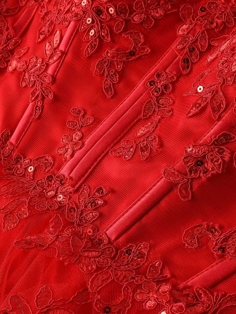 Close-up of the red dress bodice showcasing the delicate lace embroidery and hidden back zipper closure.