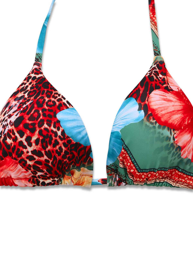 Close-up of the bikini top highlighting the contrast between the bold red leopard print and the blue floral patterns.