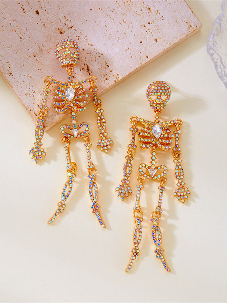 A flat lay view of the earrings on a light surface, highlighting the articulated joints and detailed stone placement.