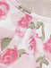 Macro view of the fabric edge and stitching on the white and pink rose print material.