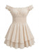 A front-facing shot of the cream mini dress showcasing the elastic smocked bodice and ruffled cap sleeves.