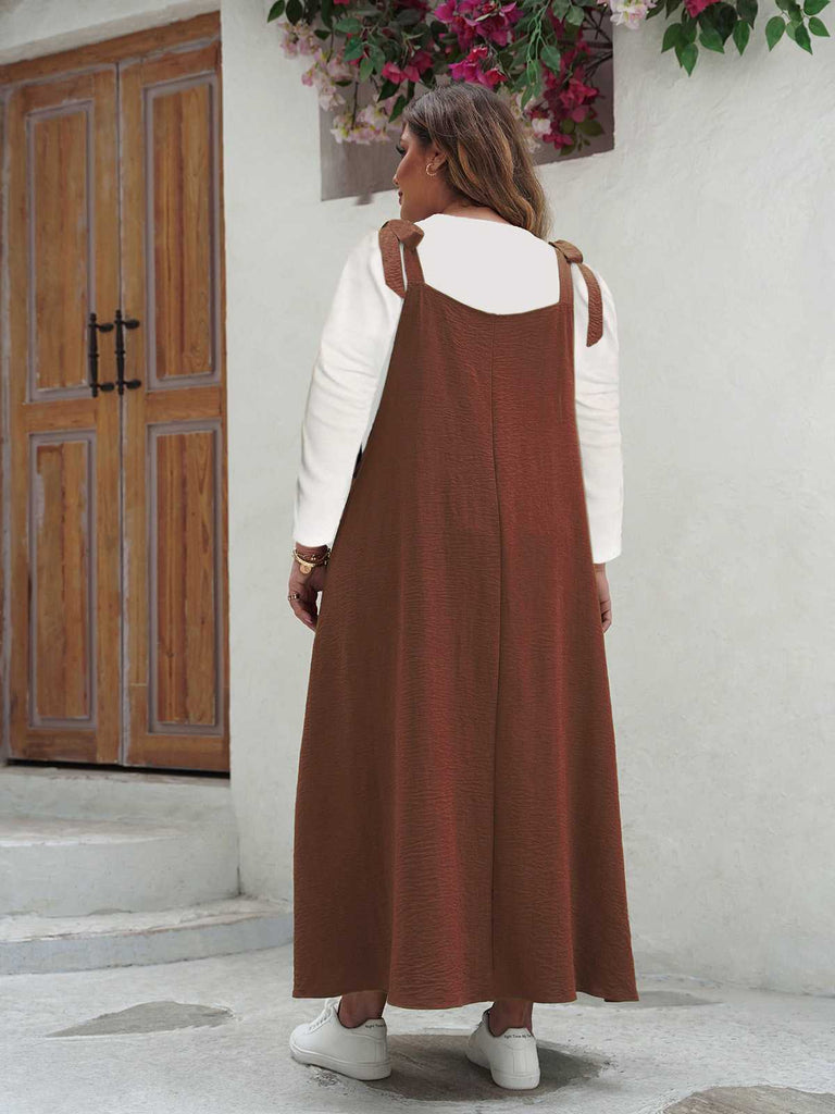 Back view of the rust-colored version of the pinafore maxi dress showing the comfortable, oversized fit.