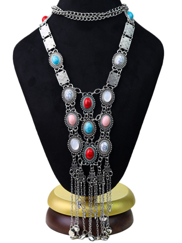 The bohemian fringe necklace displayed on a black jewelry bust to show the full scale and arrangement of the stones.