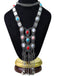 The bohemian fringe necklace displayed on a black jewelry bust to show the full scale and arrangement of the stones.