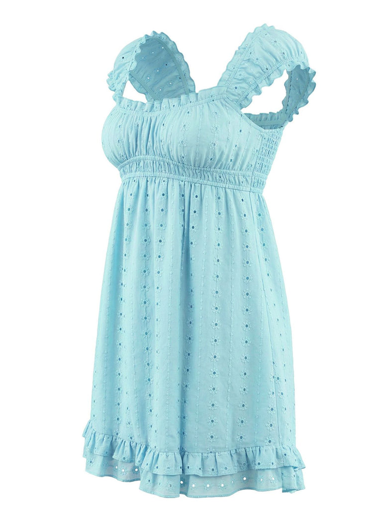 Side profile of the light blue eyelet dress showcasing the smocked chest and ruffled shoulder straps.