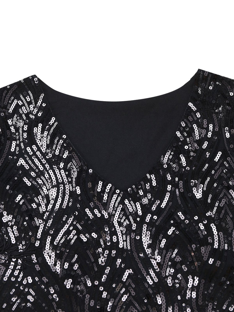 Close-up of the sophisticated V-neckline and intricate sequin embroidery pattern on the black fabric.
