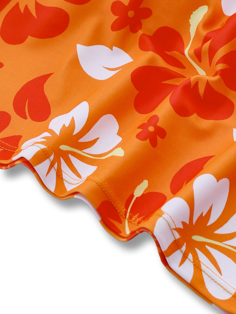 Close-up of the vivid hibiscus flower print and high-quality stitching on the hem of the orange bikini set.