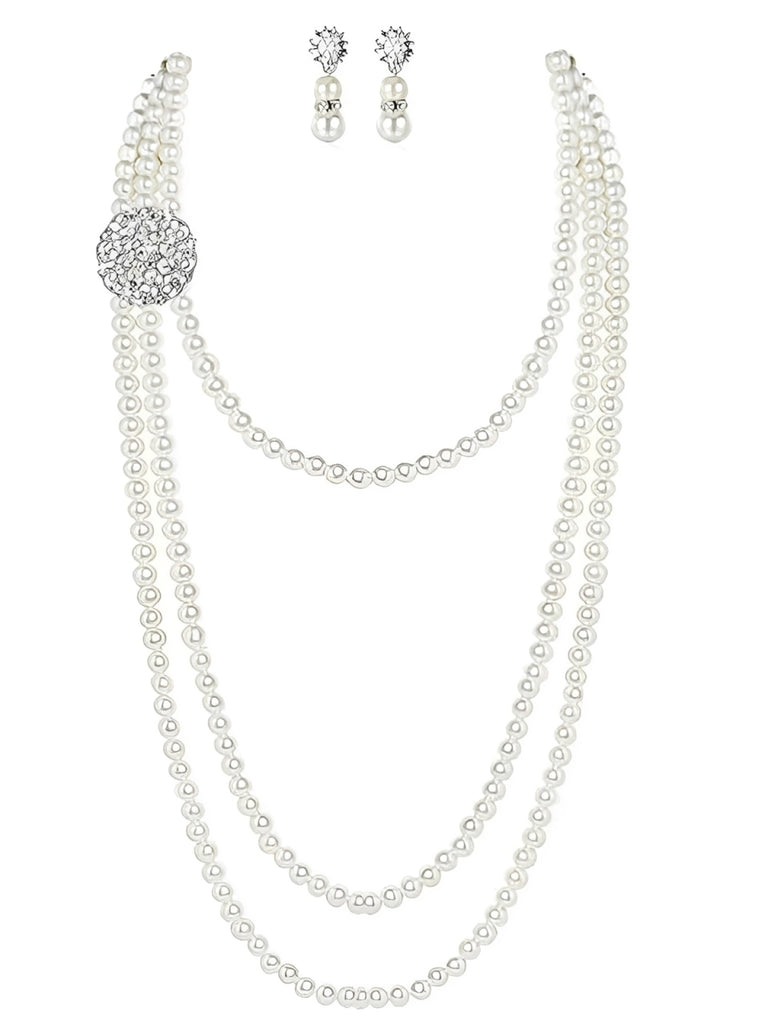 A vintage-inspired jewelry set featuring a multi-layer faux pearl strand necklace with a crystal brooch accent and matching pearl drop earrings.