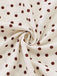 Close-up of fabric with polka dots on a white background