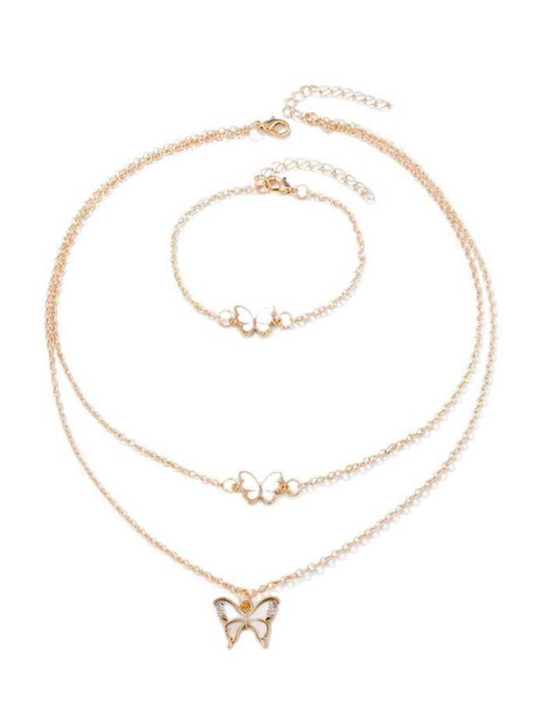 Gold butterfly necklace and bracelet set on a white background