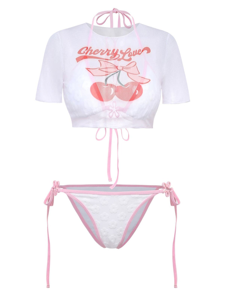 Front view of the white cropped swim tee with a cherry graphic and pink tie-front detail.