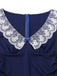Close-up of the delicate white floral lace collar and the center blue ribbon bow on the navy dress.
