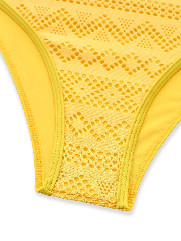 Close-up of the leg opening and the layered geometric lace pattern on the yellow fabric.