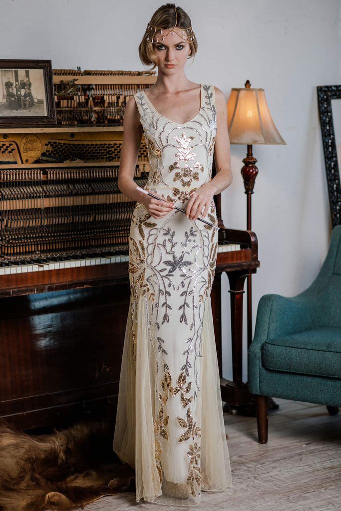 model in an Apricot 1920s Sequin Maxi Dress with flower and leaf pattern