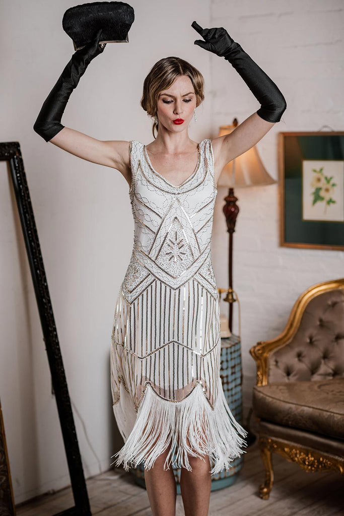 This White 1920s Fringed Flapper Dress wraps her in 1920s elegance, one twirl at a time